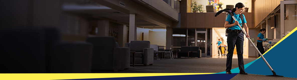 A double-height commercial atrium, glass frontage and polished stone floor, immaculately maintained.
