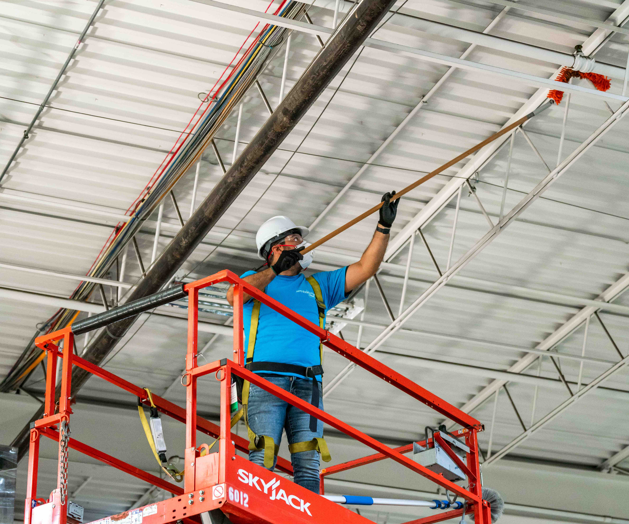 Full-height interior glass being cleaned, a squeegee pass leaving a clear band across the pane.